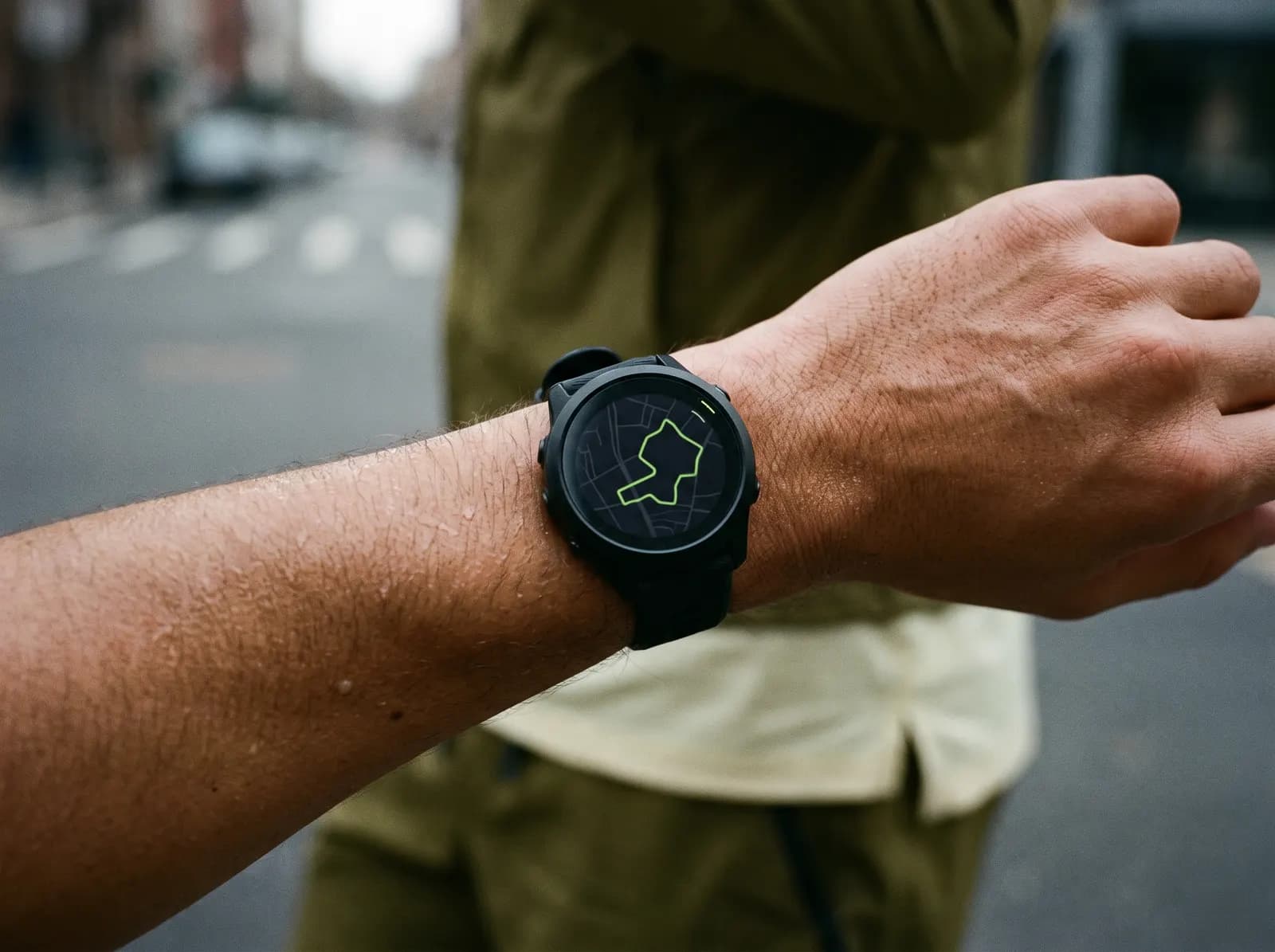 A GPS watch showing a route line on a runner's wrist