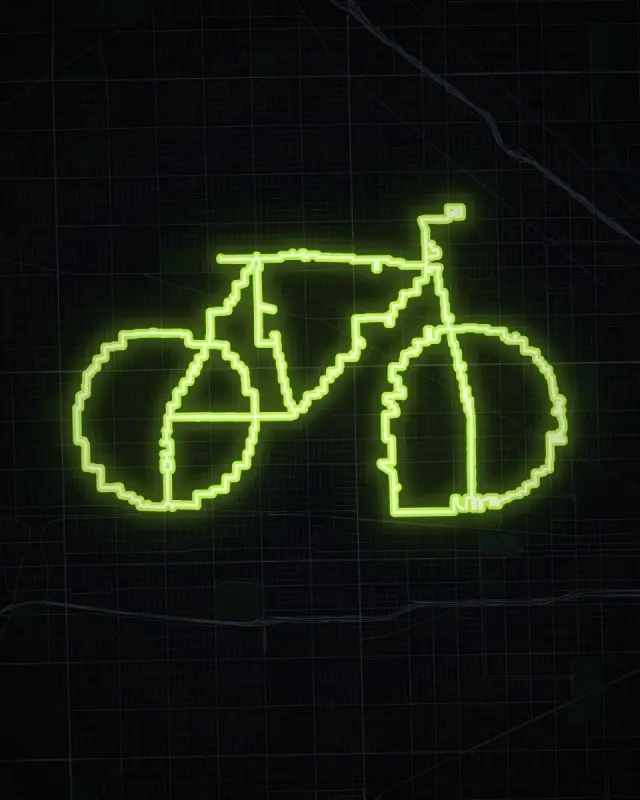 A bicycle-shaped GPS art route across Chicago's West Side, glowing green on a dark map